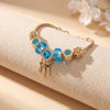 Aestify™ Aqua Dream Charm Bracelet – 18K Gold Tone | Premium CZ + Crystal Charms